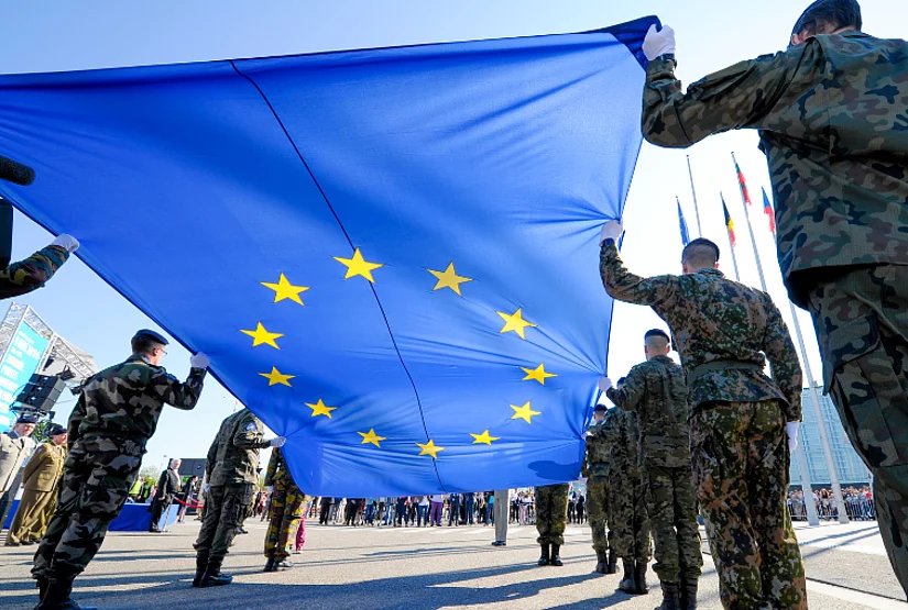 Soldiers from EU countries carrying the EU flag.