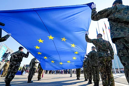 Soldiers from EU countries carrying the EU flag.