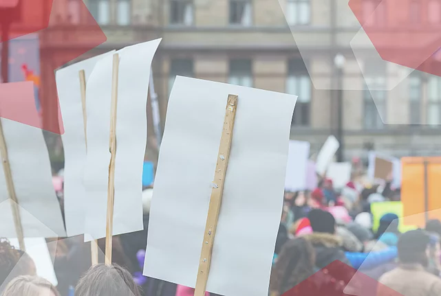 Protesters holding up posters.