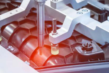 Robotic arms on an assembly line.