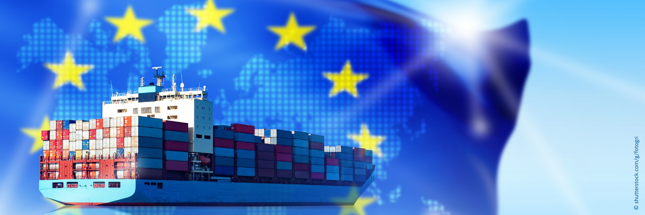 A cargo ship with an EU flag in the background.