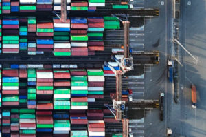 Aerial view of a port with colourful containers stacked on top of one another.
