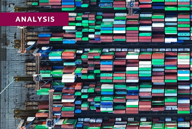Aerial view of a port with colourful containers stacked on top of one another.