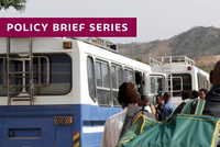 Repatriation of 232 Ethiopians across the Mereb Bridge: People with luggage waiting between busses and a blue UN sign.